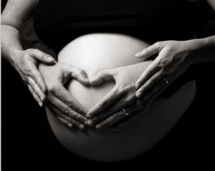 Pregnant woman with husband's hands