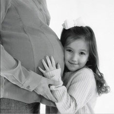 Pregnant woman with little girl 